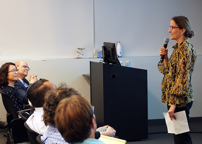 Prof. Heather Maynard in front of the room, introducing Prof. Erick Carreira.